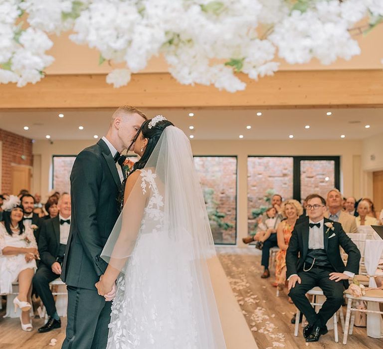 Bride and groom share their first kiss as a married couple 