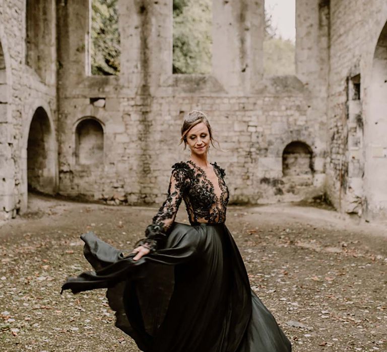 Bride in lace embroidered long sleeve plunging black wedding dress 