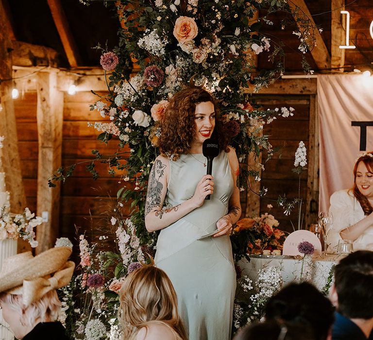 Moon maiden maid of honour reads out a wedding speech at the wedding reception 