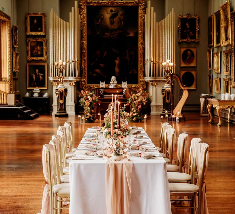 Traditional wedding tablescape at country house wedding venue with orange and red and gold colour palette 