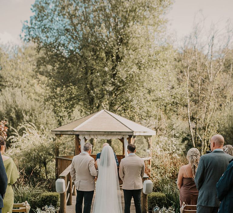 The groom, father of the bride and the bride at the outdoor wedding ceremony at Chycara wedding venue 