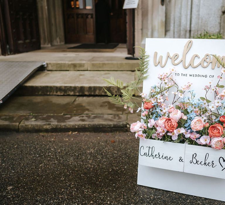 Colourful pastel flowers on wedding welcome sign 