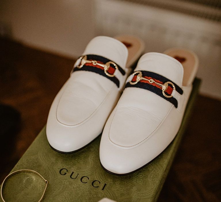 White Gucci wedding shoes with wedding rings in velvet ring box 