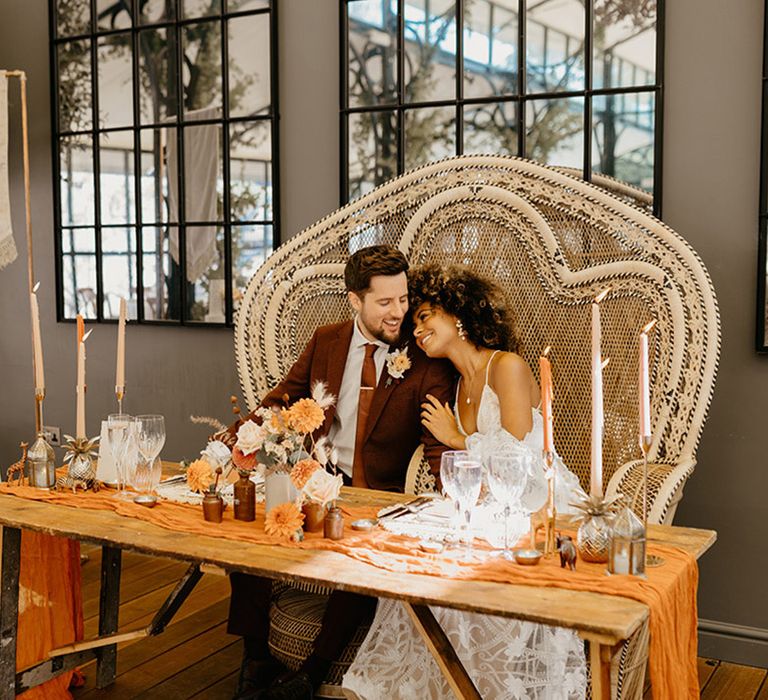 Boho peacock chair for the wedding sweetheart table the bride and groom sit at 