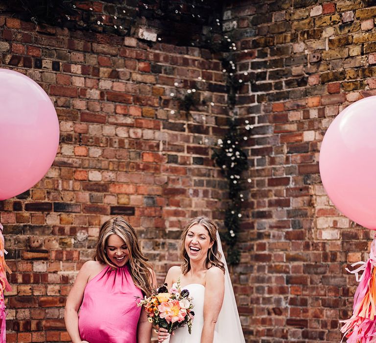 Pregnant maid of honour in bright pink satin bridesmaid dresses 