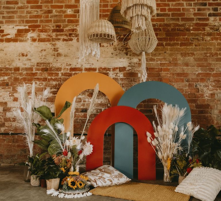 Chill out area with cushions, colourful structured altar and dried flowers 