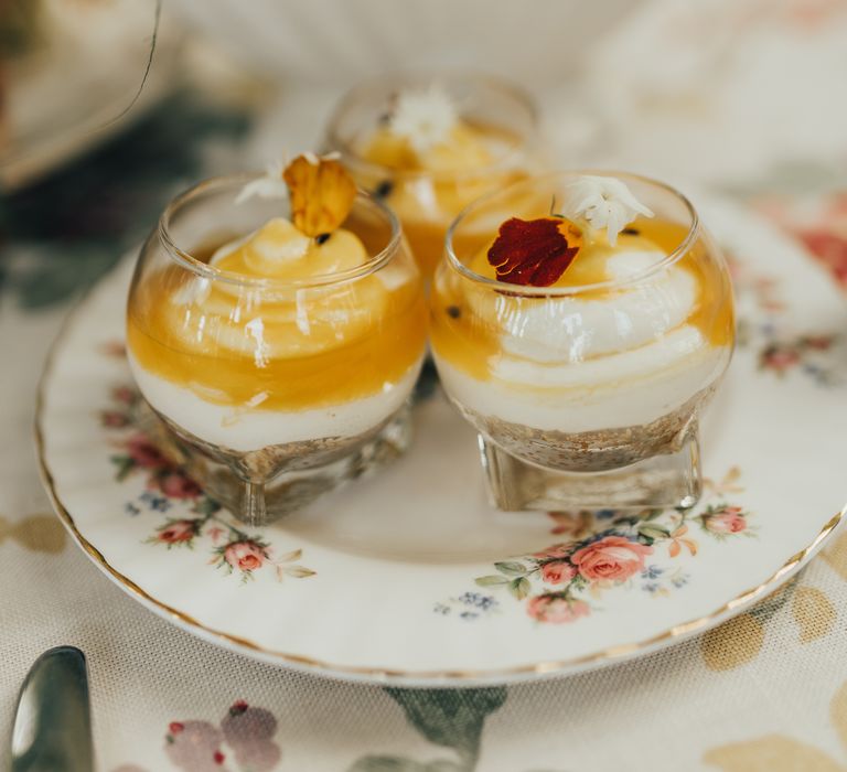 Dessert with edible flowers on rose china plate 