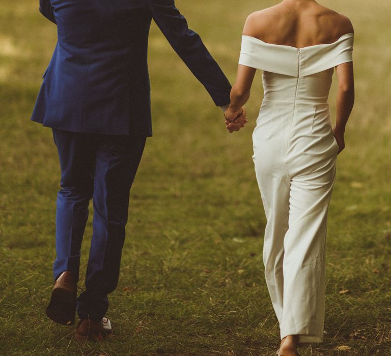 Bride in off the shoulder jumpsuit for evening wedding 