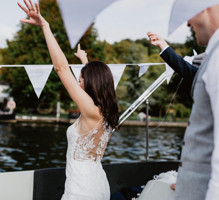 Bride dances on boat during wedding reception 