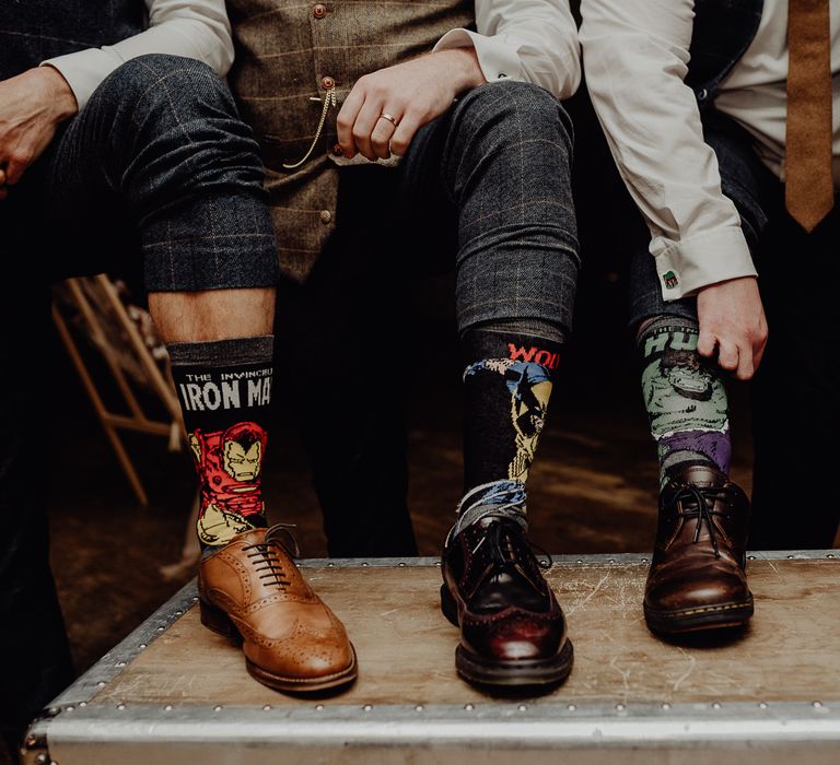 Groomsmen wearing Marvel superhero socks