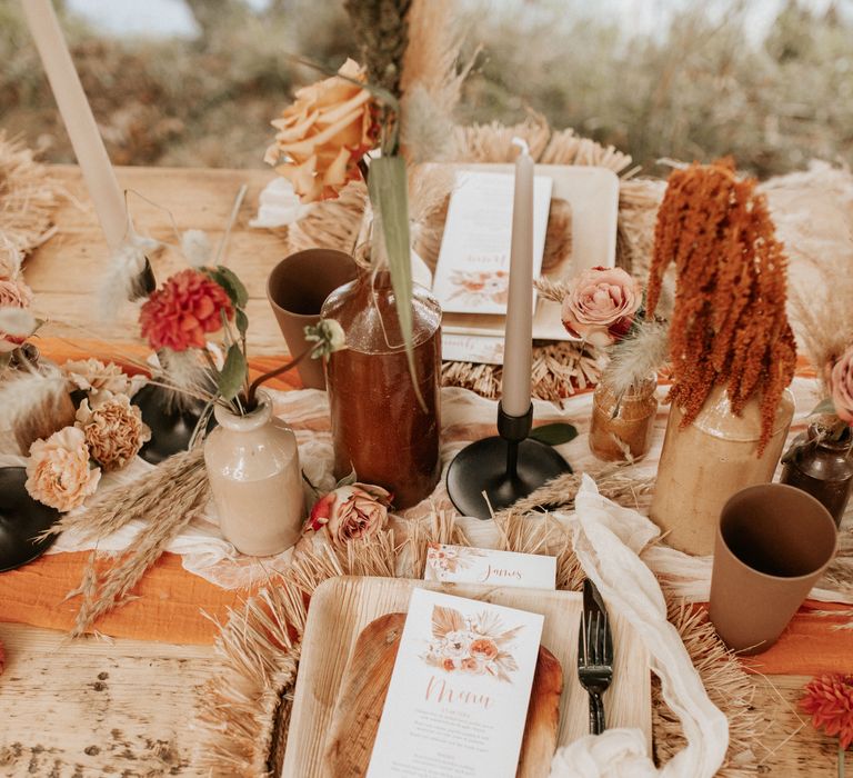 Table decor with wooden plates, vases and Autumnal floral decor 