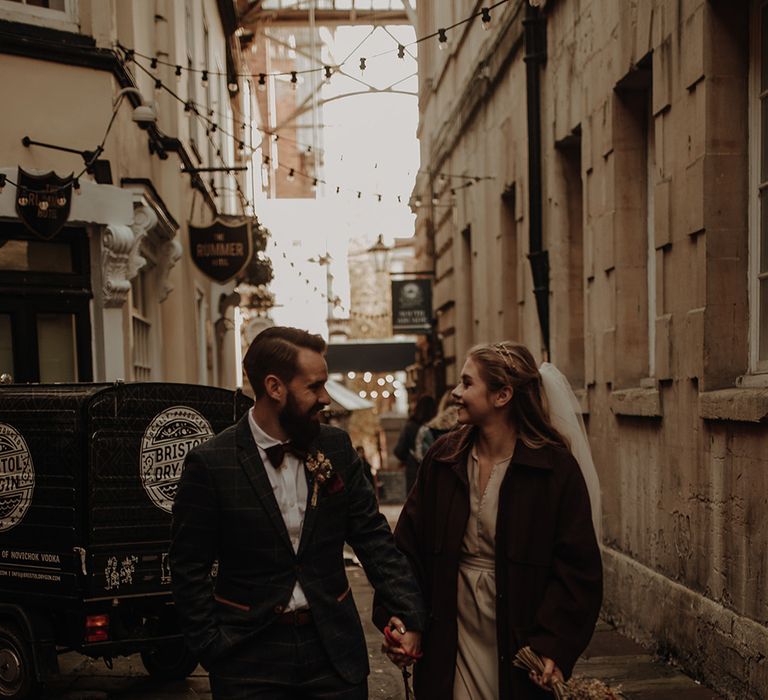 Bride and groom walk the streets of Bristol at city elopement with their pet dog