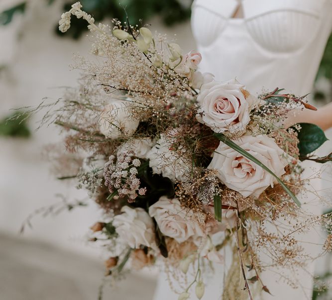 Bouquet of pale pink roses and dried grasses 