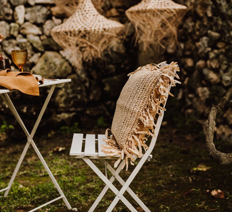 White wooden chair with heavy woven pillow