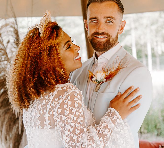 Bride looks lovingly at groom on wedding day during Lion King themed wedding