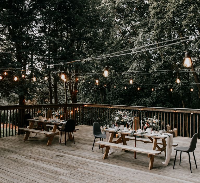 Outdoor wedding reception with fairy lights above 