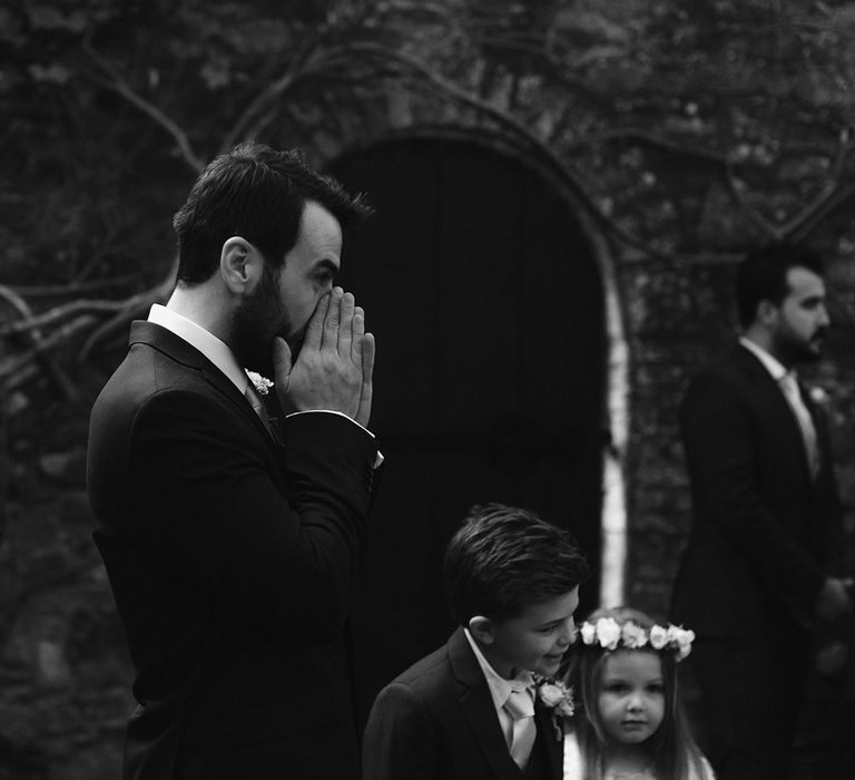 Groom in black Hugo Boss suit waits for bride in the Moon Garden at Drenagh Estate wedding