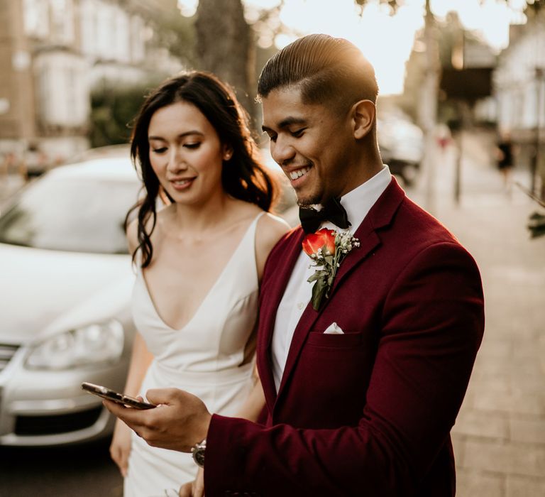 Bride and groom sharing a video call with friends at intimate wedding 