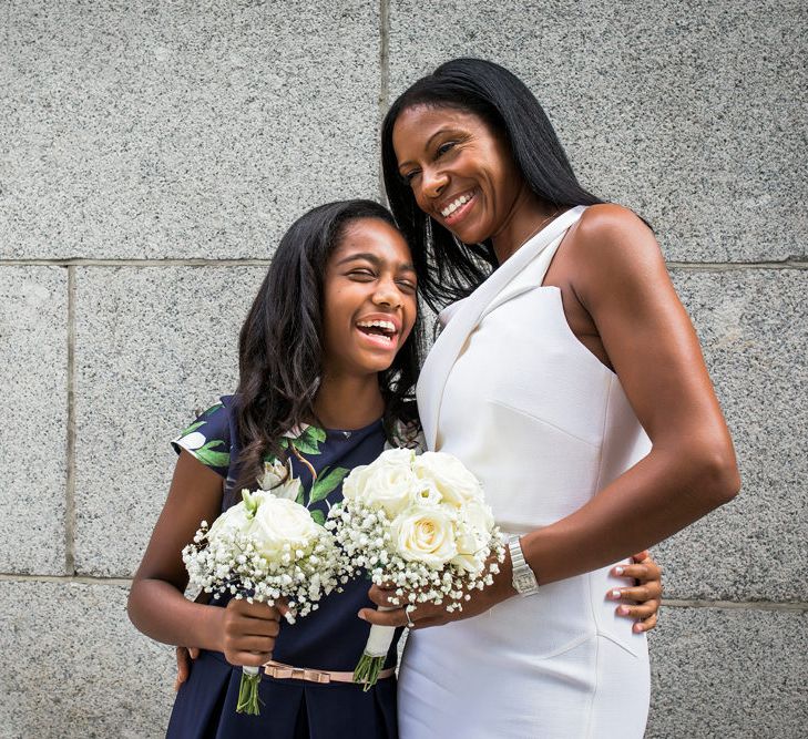 Bride in a Roland Mouret dress with her daughter in a navy dress at intimate wedding 