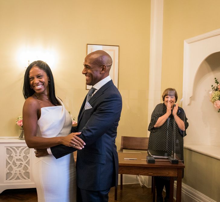 Intimate Chelsea Town Hall wedding ceremony with bride in a one shoulder Roland Mouret dress