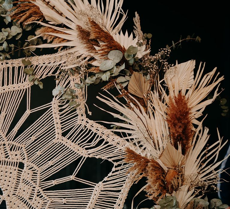 Macrame decor surrounded by dried florals