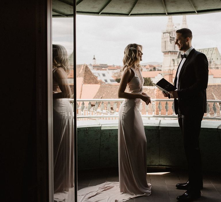 Bride and groom reading their vows on the balcony at Amadria Park Hotel in Croatia