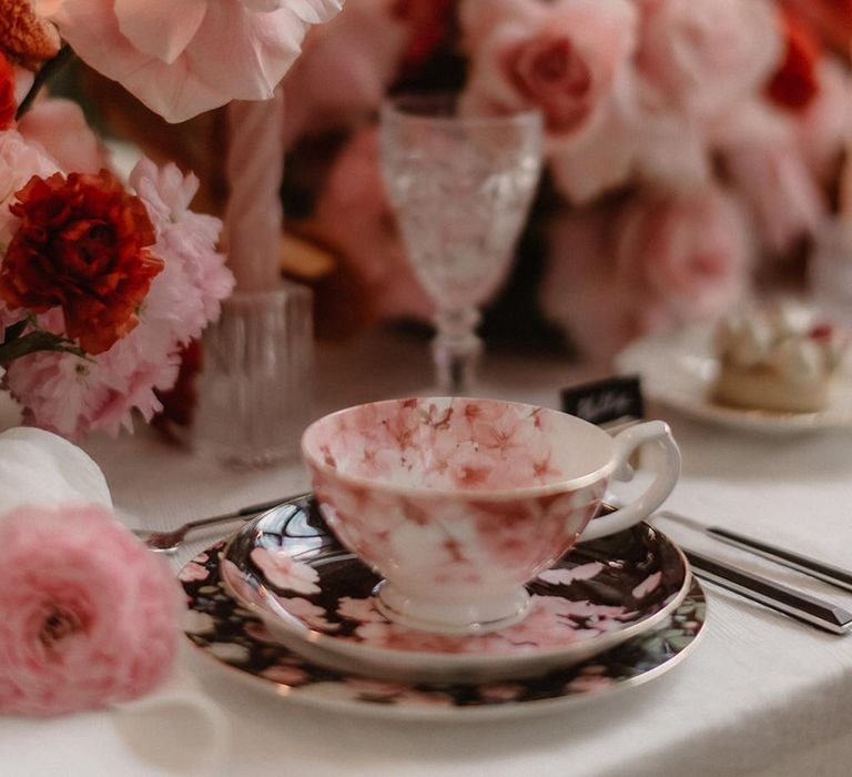 Pink wedding flowers with blossom patterned wedding teacup and saucer