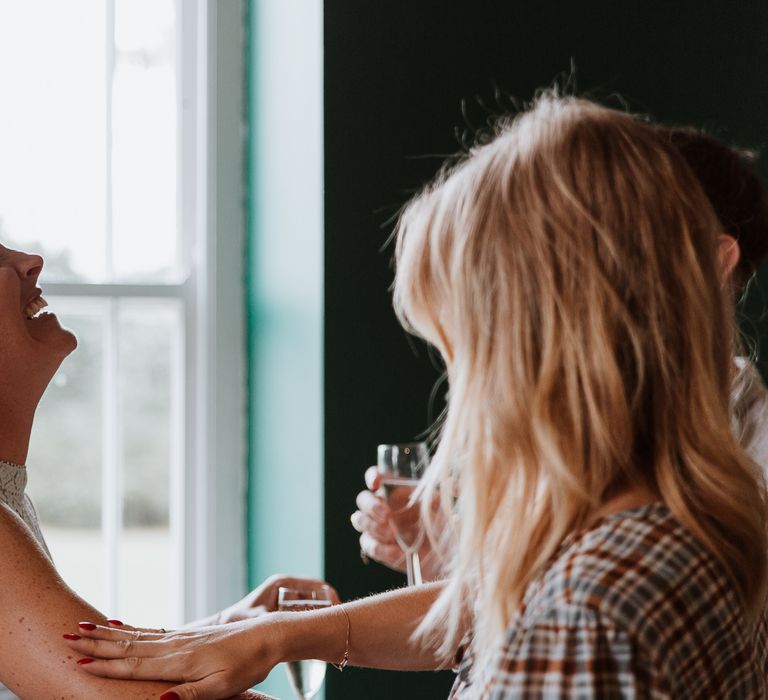 Bride laughs on the morning of her wedding day