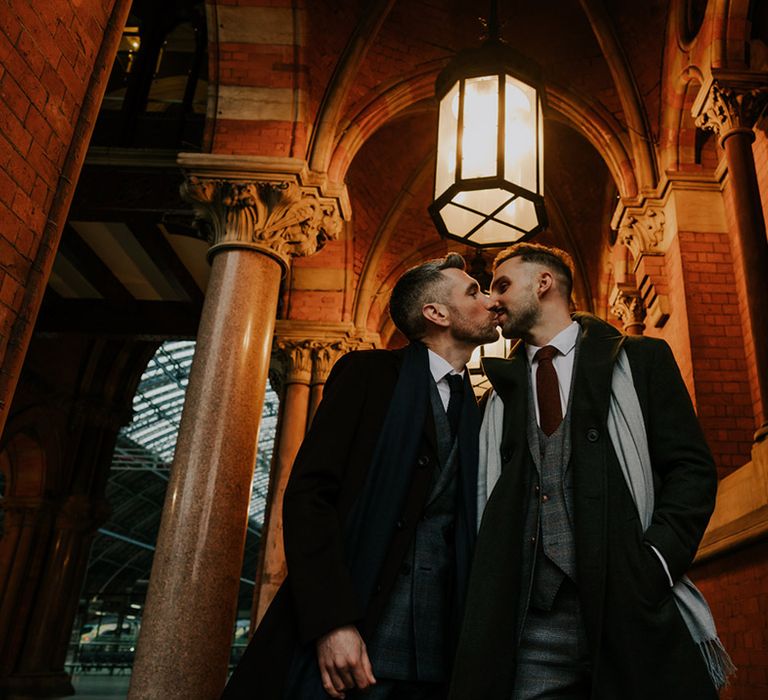 Grooms kiss one another in St Pancreas train station before wedding day in London