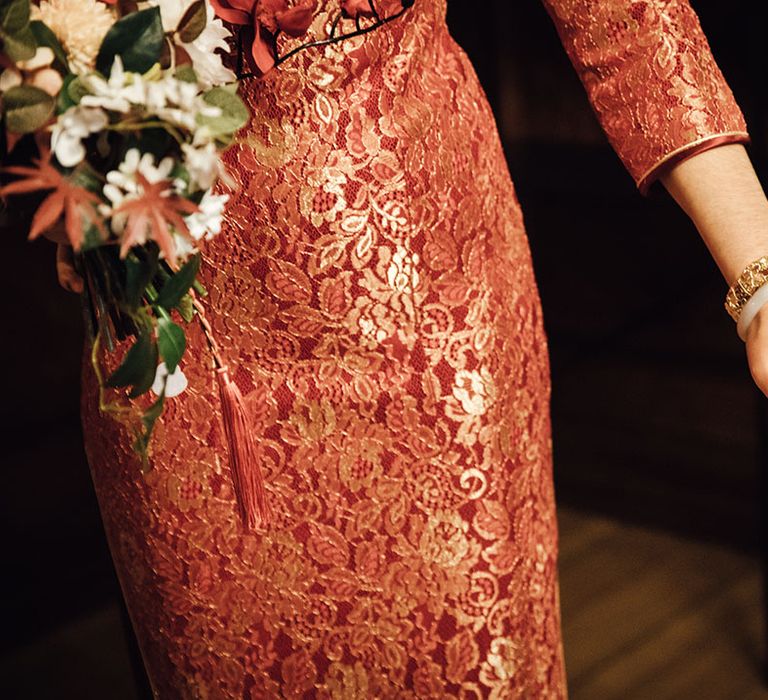 Bride in red and gold dress with red nail details