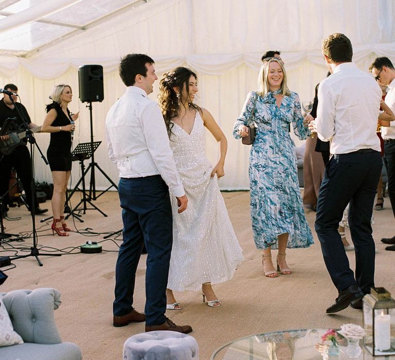 Bride in an appliqué wedding dress groom dance during the marquee wedding reception