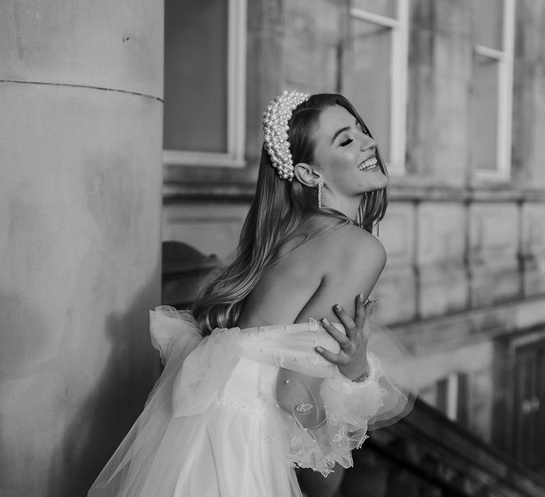 Black and white portrait of a stylish bride on St. George's Hall, Liverpool with a pearl headband 