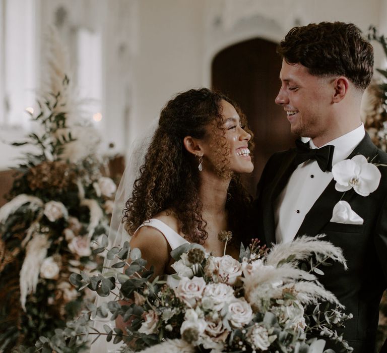 Bride & groom look lovingly at one another on their wedding day