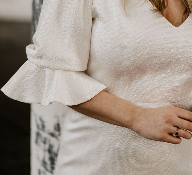 Wedding dress with elbow length flutted sleeve detail 