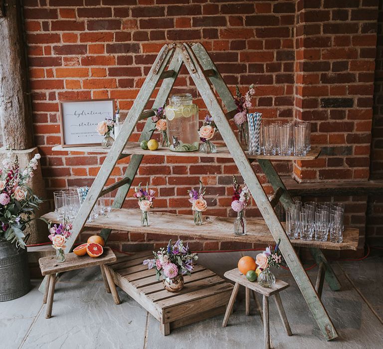 Hydration station made from rustic wooden ladders to keep guests refreshed in hot summer weather 