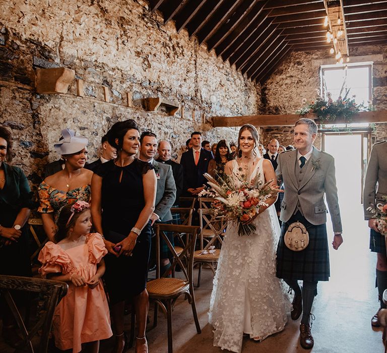 Rustic wedding ceremony in old mill at Cardney Estate in Scotland with bride in flower lace skirt wedding dress