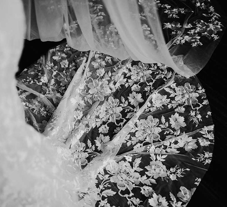 Sheer floral lace train on bride's wedding dress 