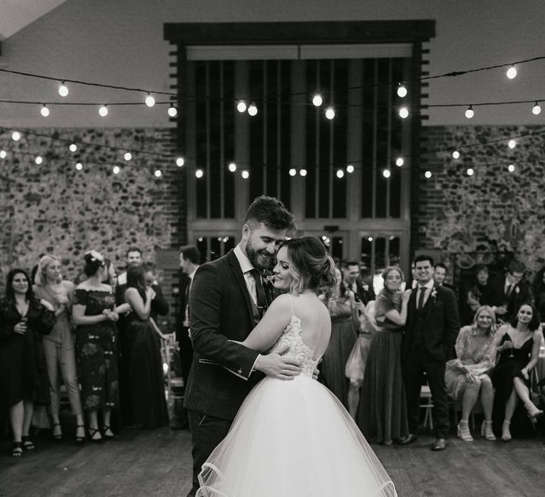 Bride in tulle princess skirt Blush by Hayley Paige wedding dress has her first dance with the groom 