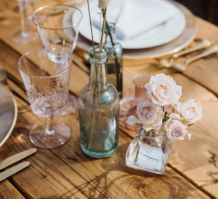 Pink and green coloured glassware with pastel flowers for the table decoration 