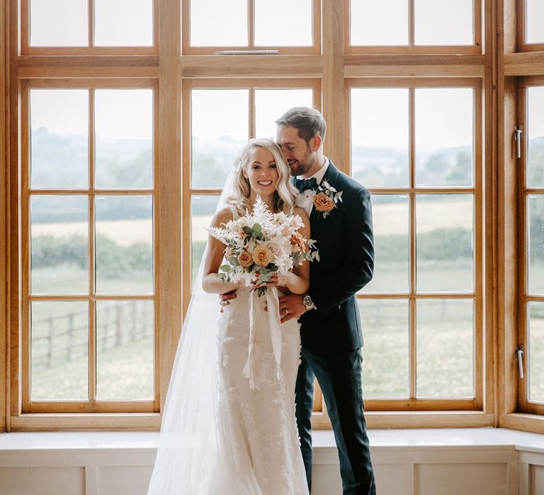 Cute couple portrait in front of windows 