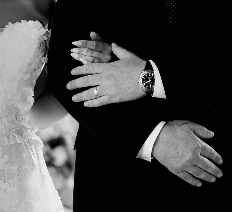 Bride in strapless flower wedding dress with stiletto nails with her father 