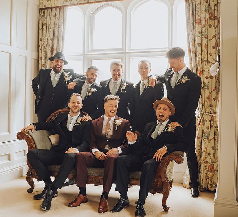 Groom sits with his groomsmen at St Audries Park wedding venue 