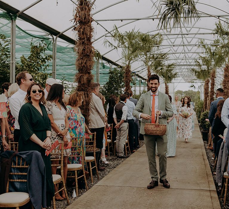 Bridal party walk down aisle scattering flowers