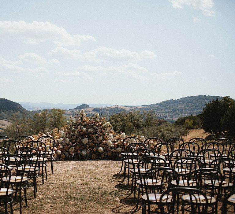 Wedding altar flowers to the front of aisle for outdoor wedding ceremony in Tuscany 