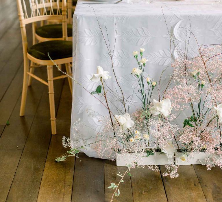 Classic wedding tablescape with pink tapered candles, white tablecloth and rose, dried flower and baby's-breath floral arrangements at St Giles House