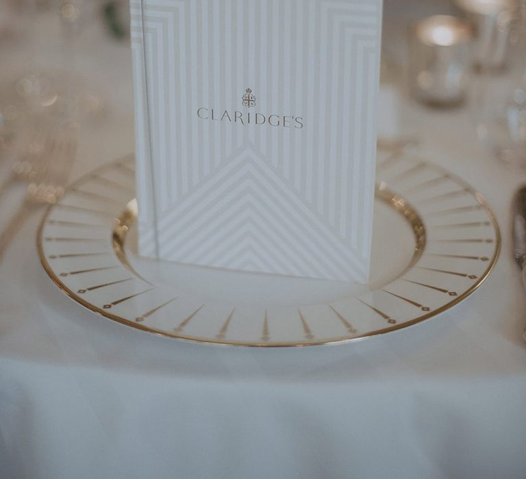 Gold charger plate with Claridge's wedding menu card on white wedding tablescape for traditional city wedding in London 