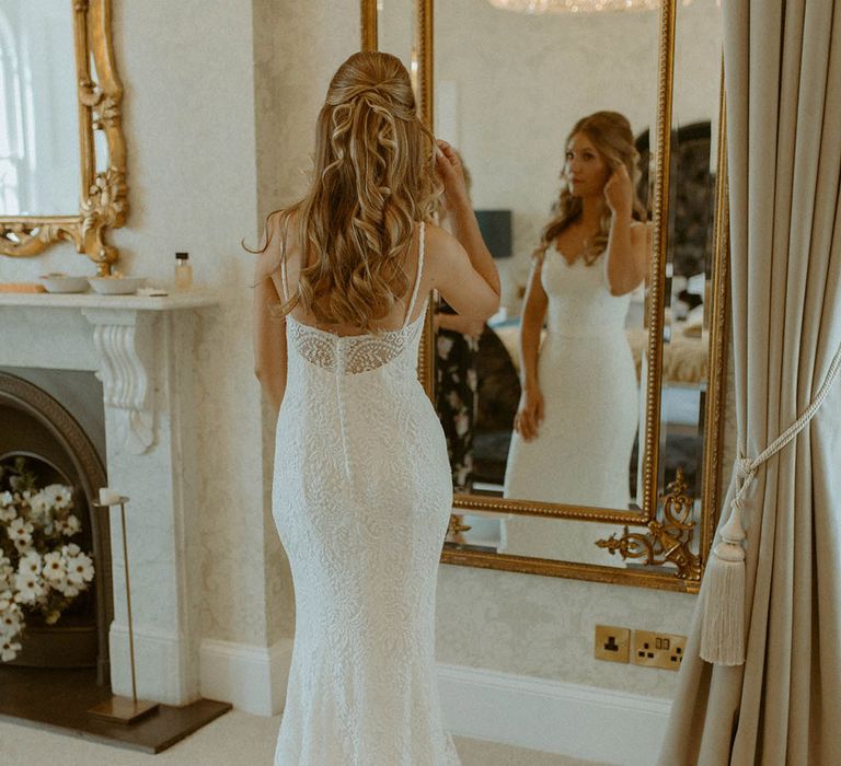 Bride in half up half down wedding hair in fitted lace wedding dress 