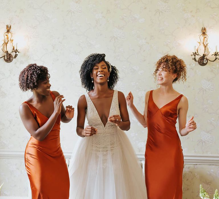 Autumn bridesmaid dresses in orange coloured dresses