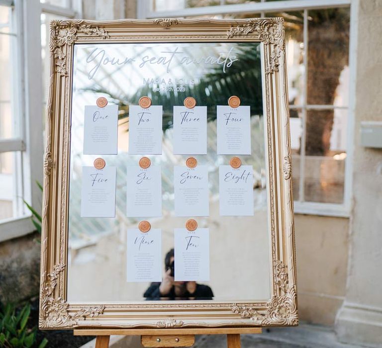 Mirrored wedding seating plan with gold frame and gold wax stickers at Syon Park