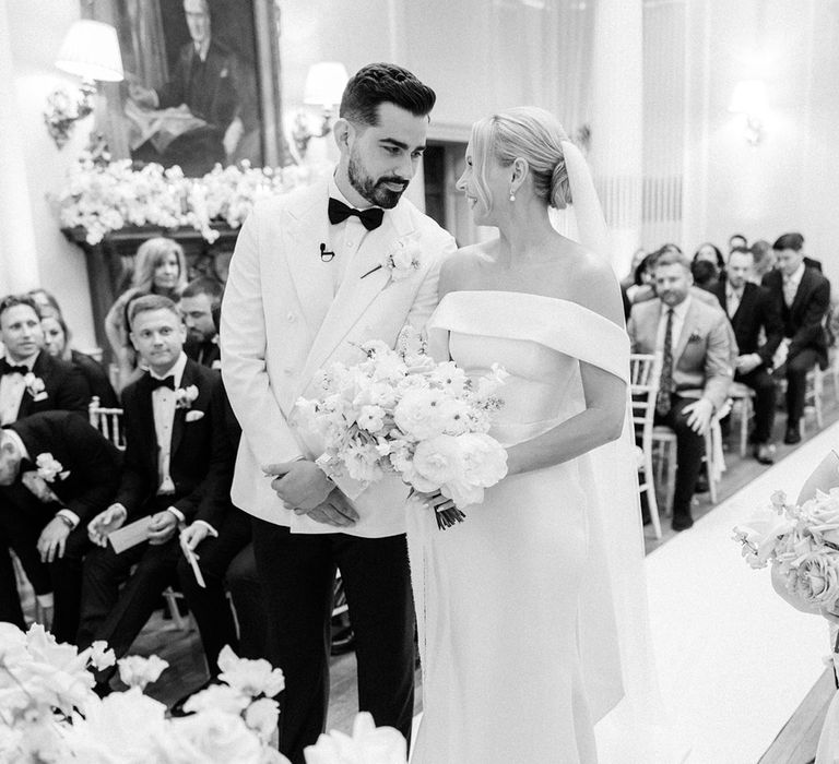 The bride and groom gaze into each other's eyes at their Hedsor House black tie wedding 